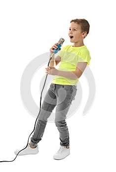 Cute boy singing in microphone on white