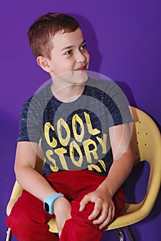 Cute boy sitting on a chair