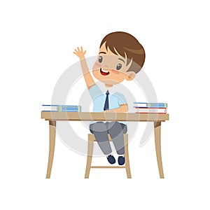 Cute boy sitting at the desk and rising his hand, elementary school student in uniform vector Illustration on a white