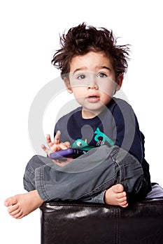 Cute boy sitting with mobile device