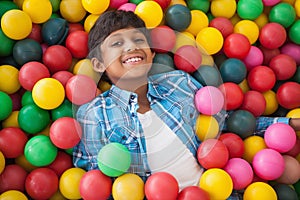 Cute boy smiling in ball pool