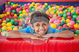 Cute boy smiling in ball pool