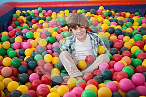 Cute boy smiling in ball pool