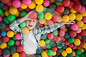 Cute boy smiling in ball pool
