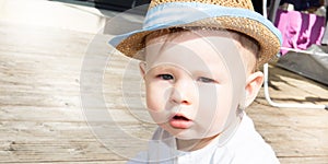 cute boy with summer hat on homme terrace photo