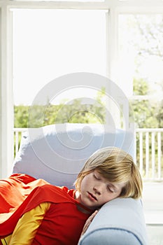 Cute Boy In Superhero Costume Sleeping In Armchair