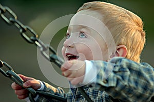 Cute boy on swing