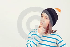 Cute boy thinking over white background. Thoughtful clever schooler. Student with serious expression