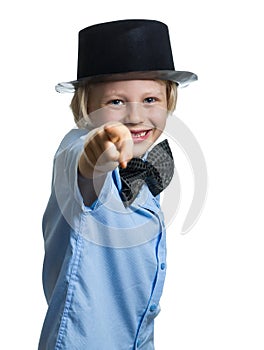 Cute boy with top hat and bow tie pointing to camera.