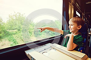 Cute boy traveling by train. Summer vacation