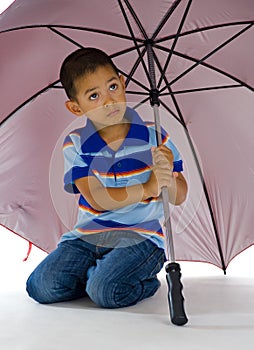 Cute boy under huge umbrella