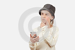 Cute boy using a smart phone over white background. Smart kid holding a mobile phone