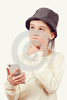 Cute boy using a smart phone over white background. Smart kid holding a mobile phone. Technology, lifestyle and people concept