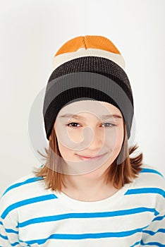 Cute boy wearing stylish woolen hat. Face portrait of eleven years old kid