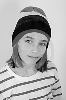 Cute boy wearing stylish woolen hat. Face portrait of eleven years old kid