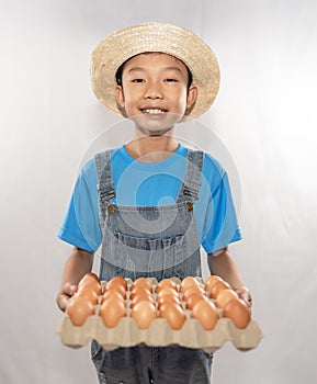 Cute boyl kids holding eggs in egg tray