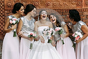 Cute bridesmaids and a bride are laughing