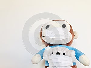 Cute brown monkey in blue and Koala wearing a face mask.