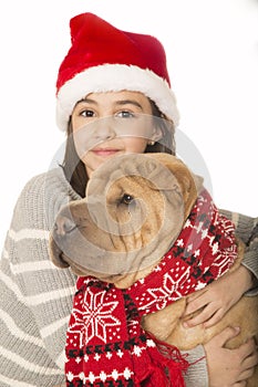 Cute brunette girl hugging a Shar Pei dog