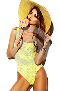 Cute brunette woman girl in summer yellow swimsuit