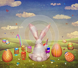A cute bunny painting of egg for easter on a hill surrounded by easter eggs