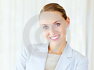 Cute business woman smiling against bright background. Portrait of a smiling young business woman with copyspace.