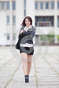 Cute business woman walking outside