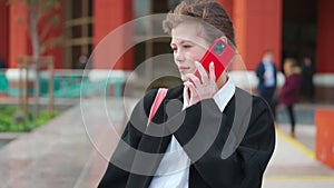 Cute businesswoman having conversation on smartphone outdoors. portrait of beautiful caucasian female business person