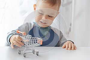 Cute buyer customer client hold shopping cart. Buy with discount. Shopping, discount, sale concept. Mall shopping. Buy