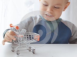 Cute buyer customer client hold shopping cart. Buy with discount. Shopping, discount, sale concept. Mall shopping. Buy