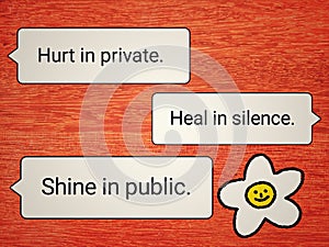 Cute card with positive advice for healing - Hurt in private. Heal in silence. Shine in public. On orange wall wooden background.