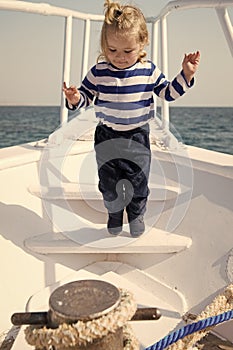 Cute and carefree. Adventure boy sailor travelling sea. Child cute sailor on yacht sunny day. Boy adorable sailor