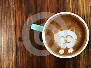 Cute cat face latte art coffee in white cup