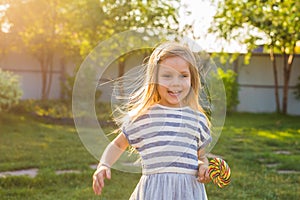 Cute cauasian baby girl and big lollipop photo