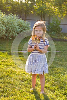 Cute cauasian baby girl and big lollipop photo