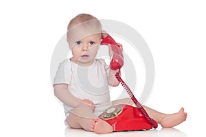 Cute caucasian baby playing with telephone