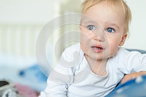 Cute caucasian blond toddler boy portrait crying at home during hysterics. Little child feeling sad. Small pensive baby after photo