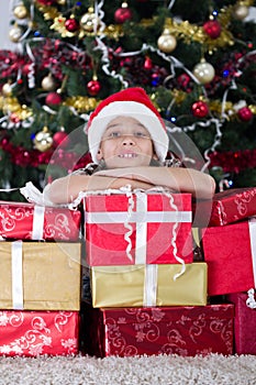 Cute caucasian boy dreaming about presents at christmas night