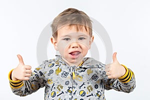 Cute little caucasian boy shows myofunctional trainer. photo