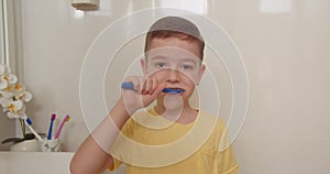 Cute Caucasian Child with white Tooth looking at mirror isolated at home. Lifestyle. Portrait happy cute young little