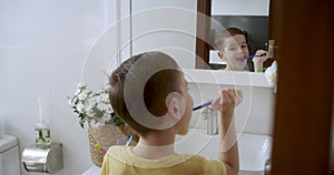 Cute Caucasian Child with white Tooth looking at mirror isolated at home. Lifestyle. Portrait happy cute young little