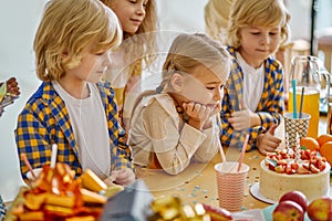 cute caucasian childen gathered to celebrate birthday