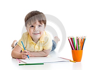 Cute child boy drawing with pencils in preschool