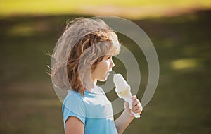 Cute child boy eating ice cream. Close up caucasian kids face. Closeup head of funny kid.
