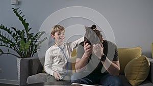 Cute child boy playing with stethoscope acting a doctor