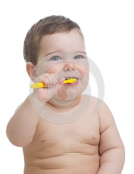 Cute child brushing teeth and smile, isolated over white.