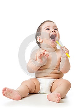 Cute child brushing teeth and smile, isolated over white.