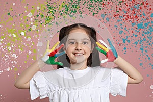 Cute child with colorful hands after painting