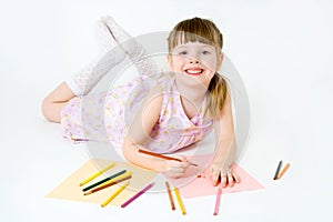 Cute child draw with colorful crayons and smile