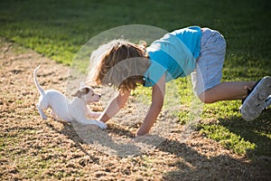 Cute child enjoying with her best friend dog. Funny doggy game. Kids playing with his pet dog.